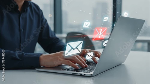 A man typing on a laptop with floating glowing envelopes showing scam alert warning, fraud alert, and email spam notifications