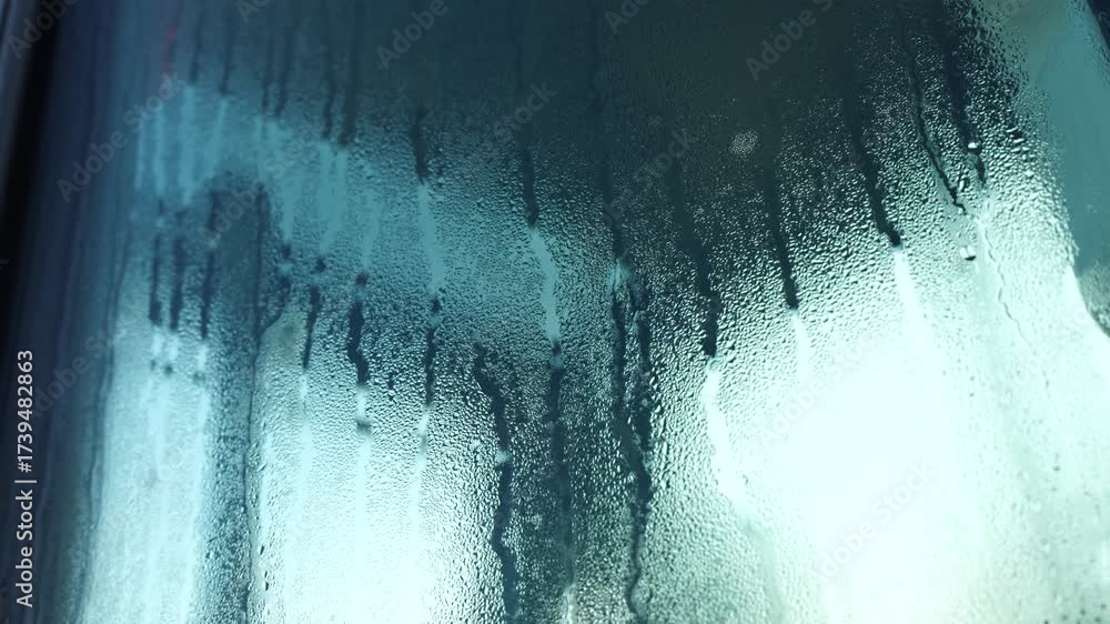 Water condensation forming streaks on glass surface, macro texture ...