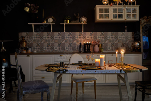 A stylish kitchen that features an elegantly candlelit table, unique decor elements, and a cozy atmosphere