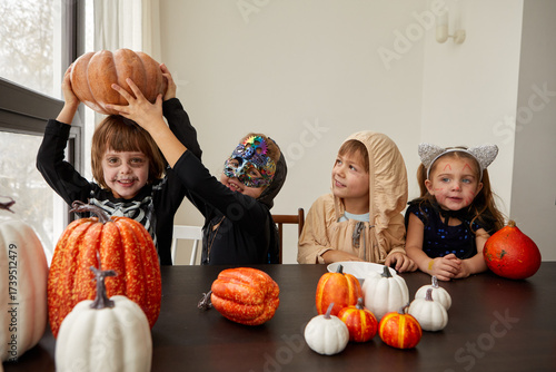 A vibrant Halloween scene with children in creative costumes and pumpkins, capturing joy and imagination