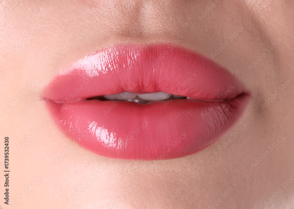 Obraz premium Woman with beautiful pink lipstick on her lips, macro view
