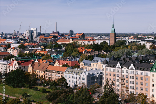 Wallpaper Mural Aerial view of colorful rooftops and the iconic tower of St. John's Church rise amidst the urban tapestry, Helsinki, Uusimaa, Finland. Torontodigital.ca