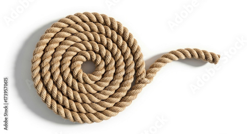 Coiled natural fiber rope on a white background