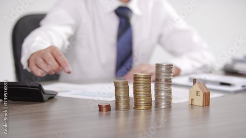 Financial Planning Concept with Coins and House Model - Business Investment and Property Management