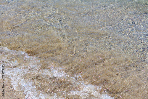 Sandy seashore with gentle waves