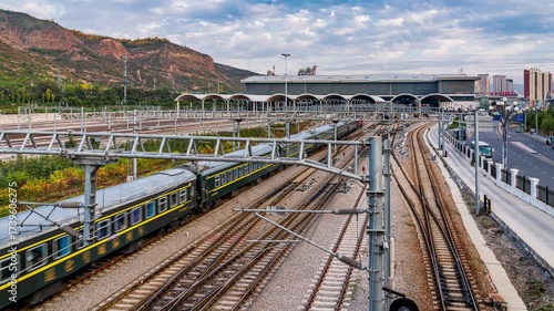 Xining Railway Station with Multiple Train Tracks and Mountain Landscape in China