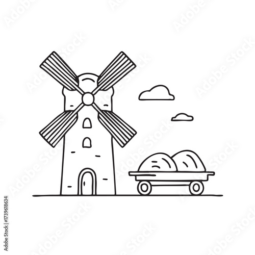 A windmill beside a cart filled with hay and farming tools