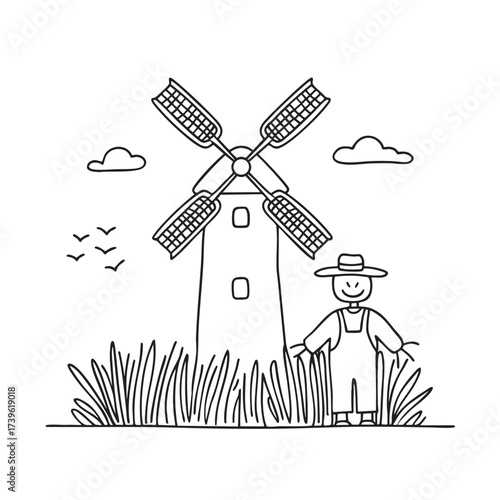 A windmill close to a scarecrow standing among tall grass