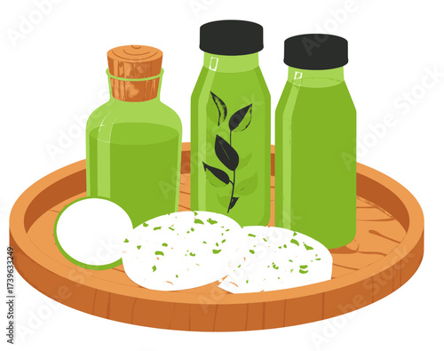 Spa Treatment with Green Bottles and White Stones on a Wooden Tray.