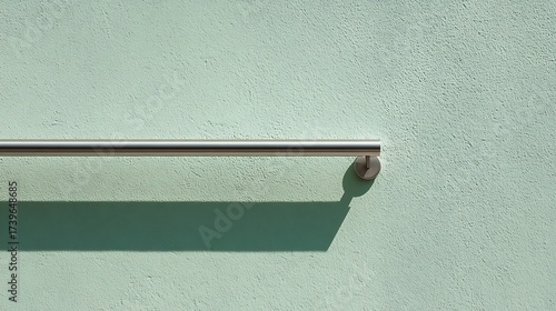 Minimalist Metal Handrail on Light Green Wall in Modern Interior