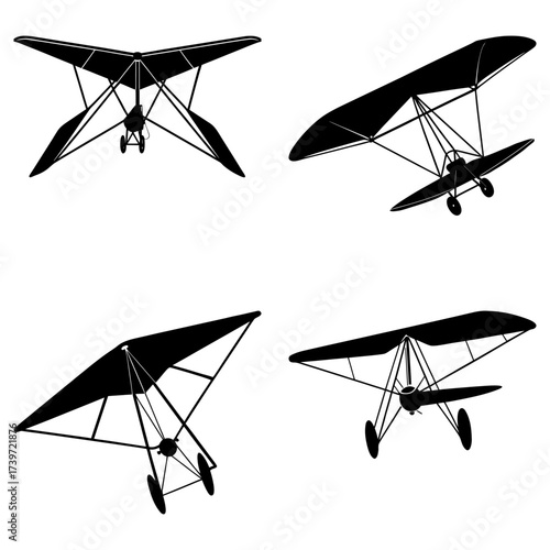 Four hang gliders depicted in black silhouette against a white background in various flying positions