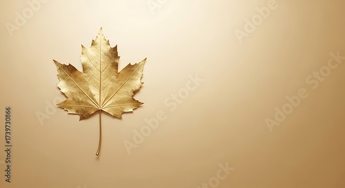 Golden Maple Leaf on Beige Background