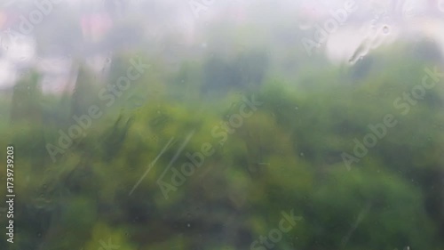 Raindrops fall on a windowsill during a rain. Raindrops on glass.