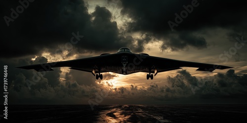 A stealth bomber flies low over a runway, silhouetted against a moody, cloud-filled sky during sunset.
