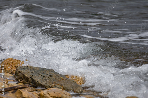 Fototapeta Naklejka Na Ścianę i Meble -  The rough Adriatic Sea in Croatia, waves lapping the stones on the beach Rab Croatia