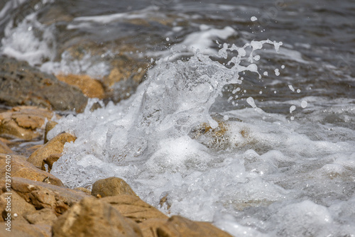 Fototapeta Naklejka Na Ścianę i Meble -  The rough Adriatic Sea in Croatia, waves lapping the stones on the beach Rab Croatia
