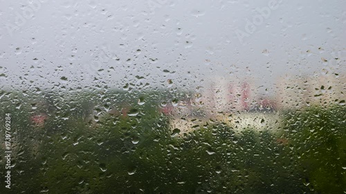 Large raindrops on glass during a rainstorm.
