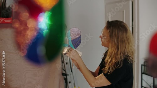 Female Stained glass artisan creates handmade art, women in DIY