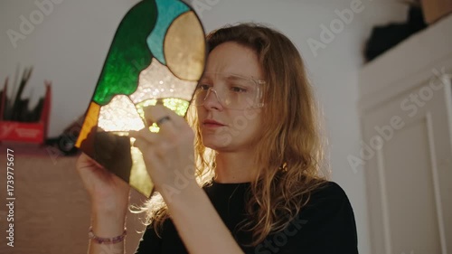 Female Stained glass artisan creates handmade art, women in DIY