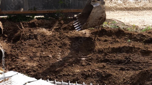An excavator is performing excavation work at a construction site.
