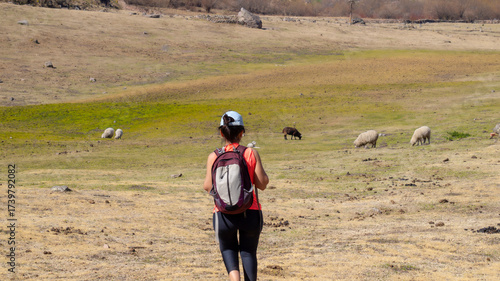 young woman hiking in a mountain area located in Tafi del Valle, Tucuman. in a spring warm morning