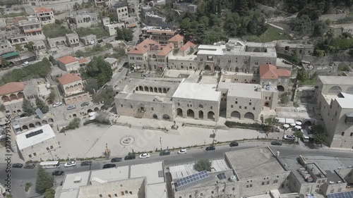 Aerial view of the historic main square in Deir el Qamar, Lebanon, surrounded by traditional stone buildings, houses, and cultural landmarks. 