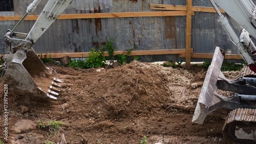 An excavator is performing excavation work at a construction site.