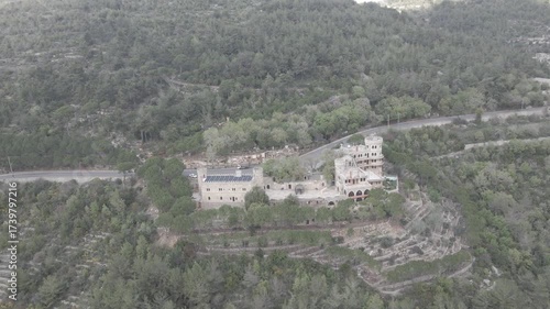 Aerial view of Moussa Castle, a famous historical landmark and museum located near Deir el Qamar, Lebanon, surrounded by forested mountains. 
