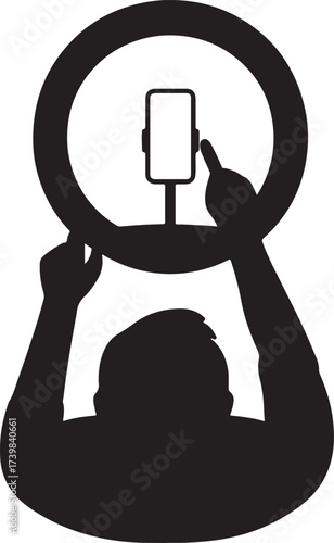Silhouette of a person holding a ring light and smartphone for content creation or vlogging setup