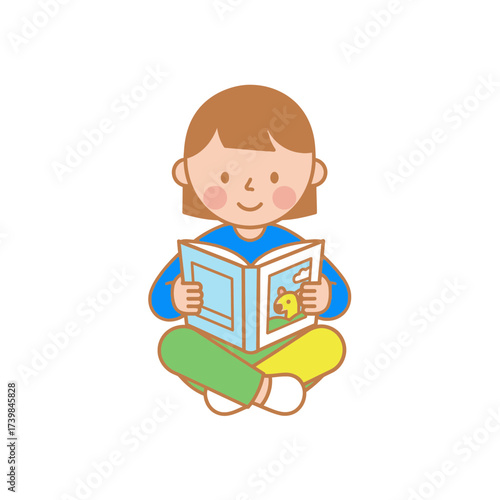 A cheerful young girl sitting cross-legged, engrossed in reading an illustrated children's book with a bright blue cover, evoking a sense of childhood joy and imagination