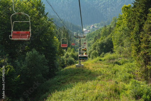 A cable car lift in the mountains in summer: a concept for travel, hiking, and ski tourism