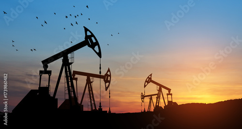 The change in oil prices caused by the war. Oil price cap concept. Oil drilling derricks at desert oilfield. Crude oil production from the ground. Petroleum production.