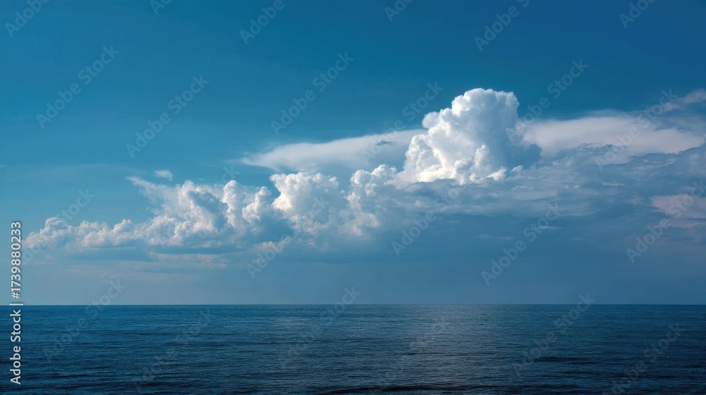 Naklejka premium Tranquil ocean water under cloudy sky, deep and serene scene.