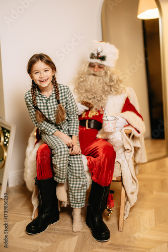 30.01.25 Vinnitsa, Ukraine: Girl Sitting on Santa's Lap in Festive Setting