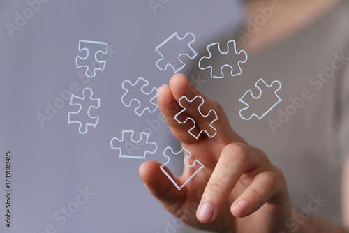 Hand connecting puzzle piec...