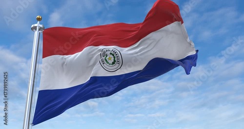 Paraguay flag with flagpole waving in wind, rolling clouds background looping, 4K video (Perfect Loop)