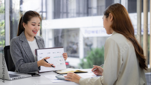 Wallpaper Mural Asian businesswomen professionals present financial data analyze reports discuss strategy achieve growth foster collaboration modern office corporate environment productive workspace Torontodigital.ca