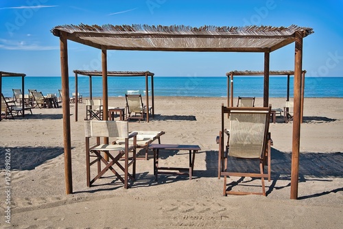 Beach resort with straw umbrellas and deck chairs, Marina di Castagneto Carducci, Tuscany, Italy
