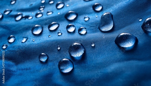 rain droplets on a blue waterproof fabric background close up