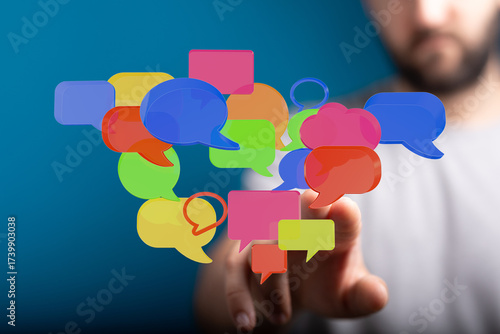 Wallpaper Mural Man reaches toward colorful speech bubbles, showcasing communication and connection in digital age. Ideal for social media, networking visuals. Torontodigital.ca