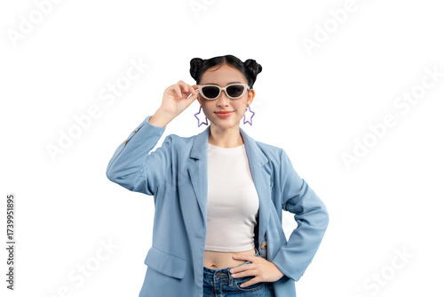 Young woman in a stylish outfit. She is wearing sunglasses and has two buns hairstyle