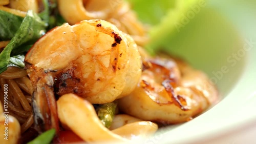 Italian spaghetti with delicious shrimp and squid, spaghetti in a white plate.