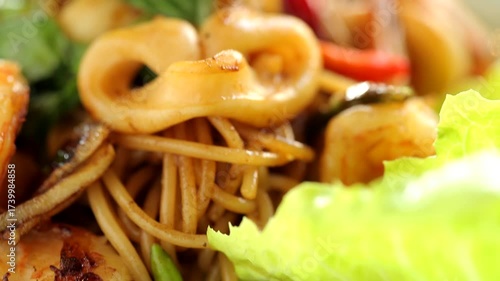 Italian spaghetti with delicious shrimp and squid, spaghetti in a white plate.
