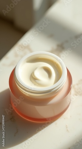 Jar of cream sitting on a table