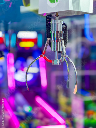 Carnival or arcade game featuring a metal claw which drops to grab a stuffed animal but rarely wins the prize