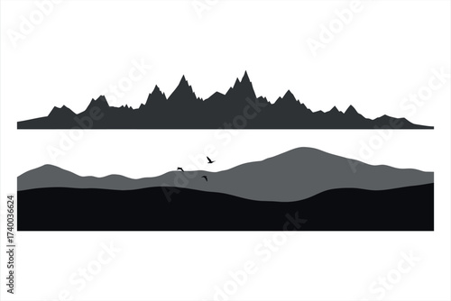 Dark silhouette of jagged mountain range above rolling hills and flying birds peaks