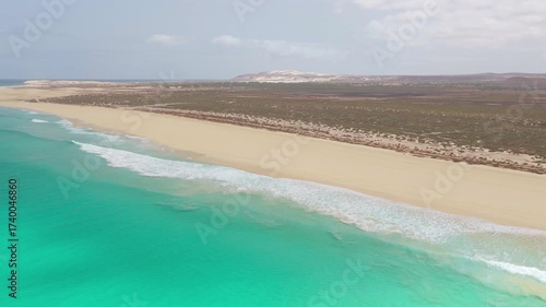 Aerial footage of Santa Monica Beach,showcasing endless white sand, turquoise waves, and a pristine,summer concept,Boa Vista, Cape Verde.