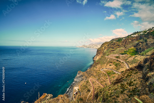 pectacular aerial view of the rugged coastline near the Cristo Rei statue in Madeira, Portugal.