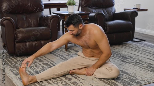 Fit Man Stretching His Legs at Home