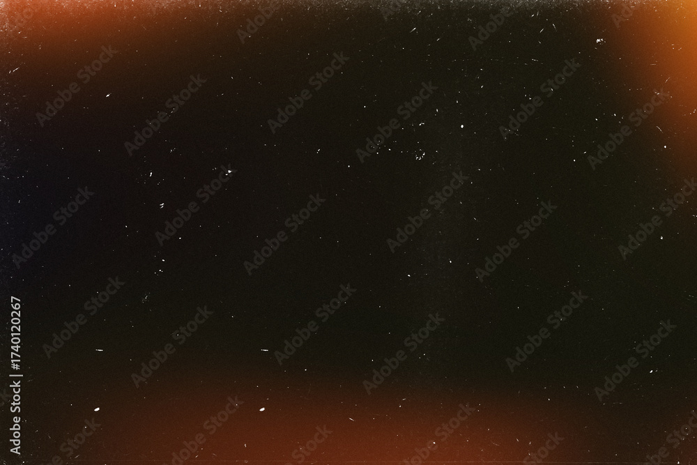 Obraz premium Light overlay, orange warm color. Blurry spots. Old film light leak texture with scratches, grain, noise and dust. Perfect as background or overlay for photo editing, video design, and digital art.